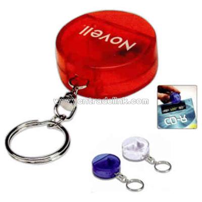 Round CD opener with key holder attached