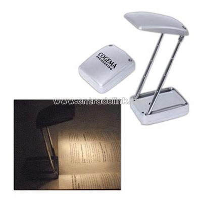 Silver collapsible reading light with flashlight
