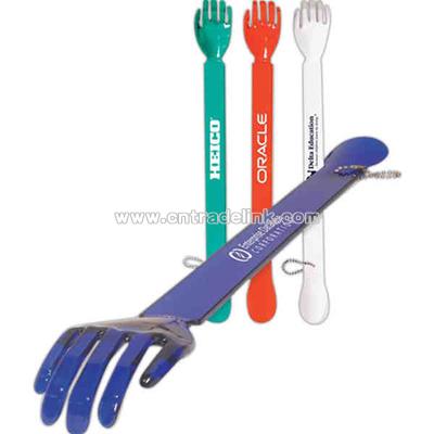 Combination back scratcher and shoe horn with chain for hanging.