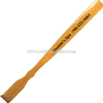 Combination shoehorn/back scratcher
