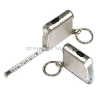 Light up keychain with flashlight and tape measure.