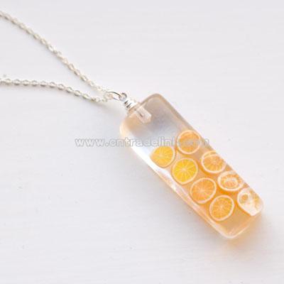 Orange Oranges resin pendant on 16 inch chain