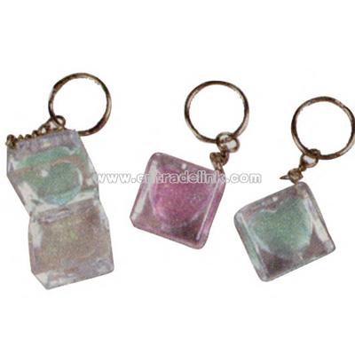 Square shaped key chain with heart shaped glitter lip gloss inlay