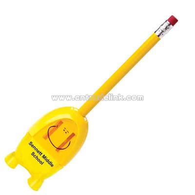 Standing smiley pencil sharpener holds pencil shavings