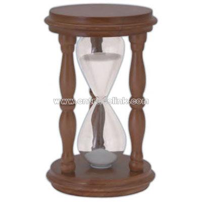 Traditional sand timer with wooden stand and white sand